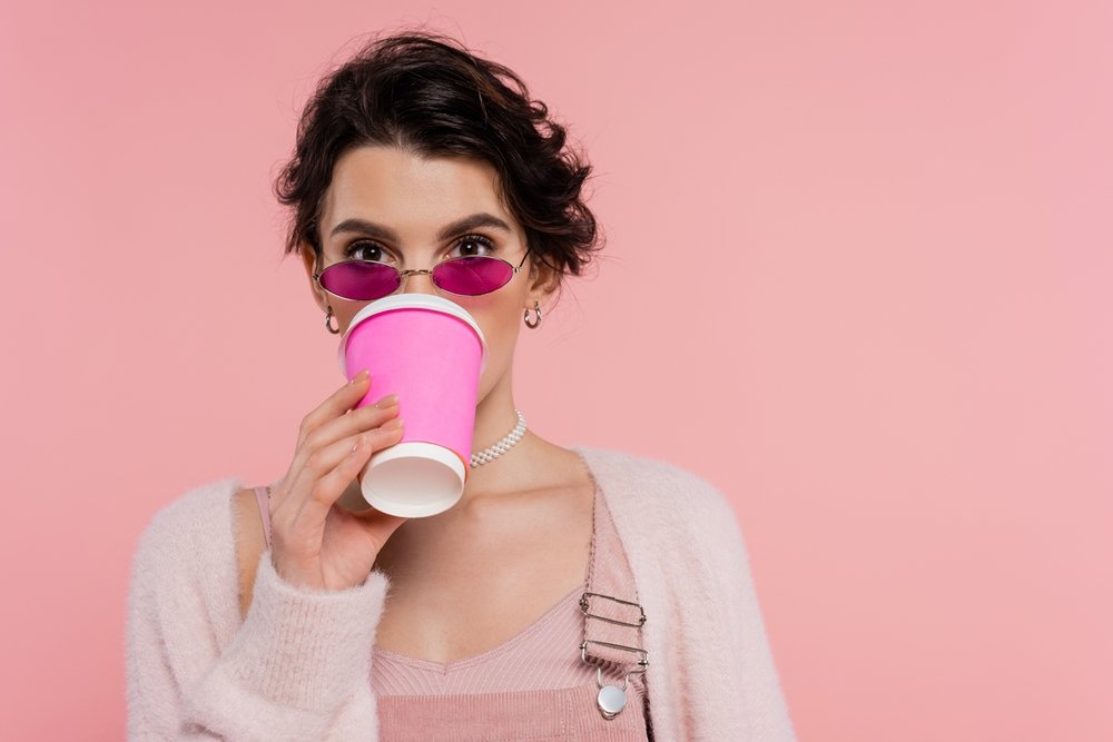 Brunette woman drinking a cup of coffee.