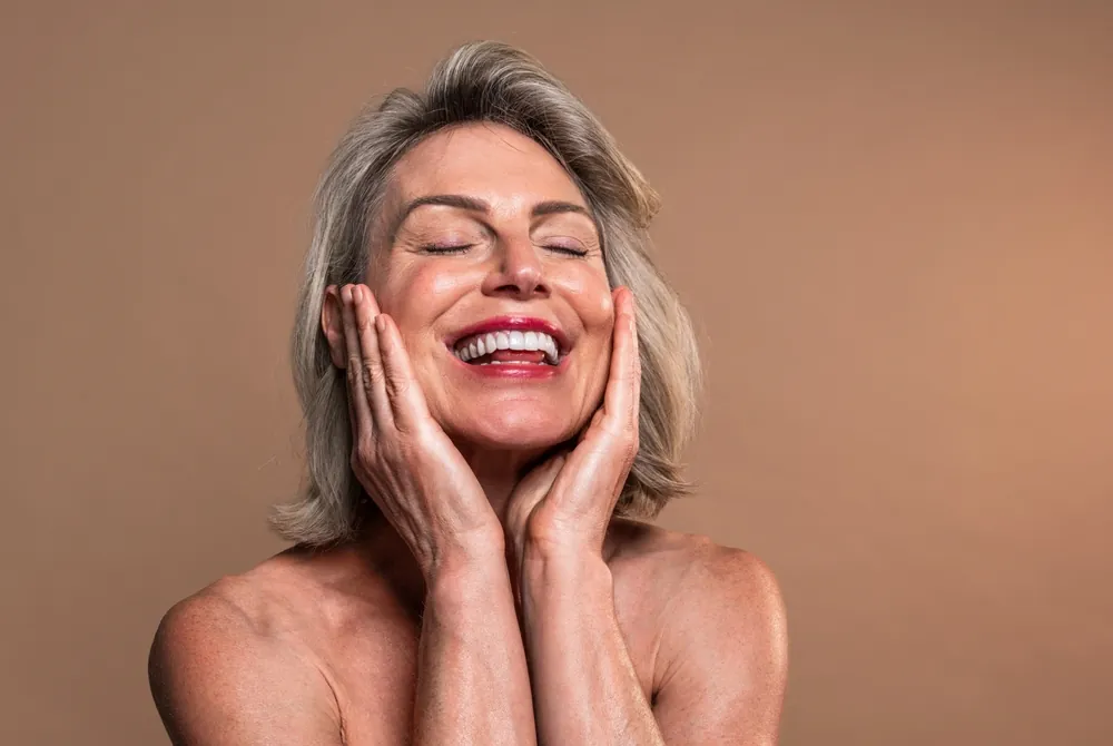 Smiling midlife woman with healthy, glowing skin representing confidence and wellness after 40
