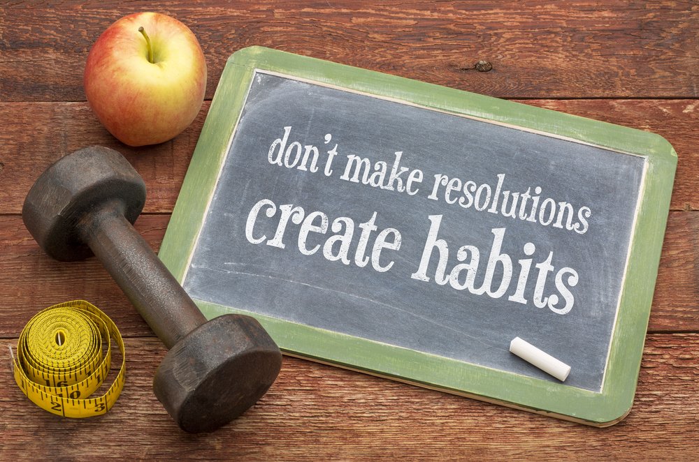 A small chalkboard that says "don't make resolutions, create habits"